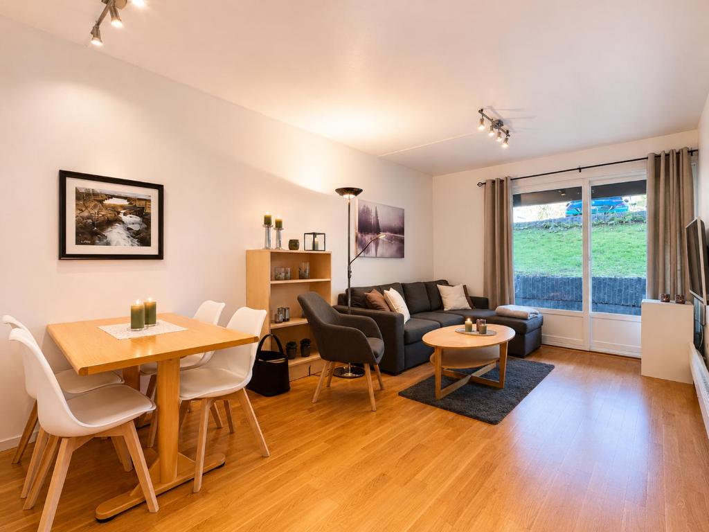 a living room with a couch and a table at Central Apartment in Geilo in Geilo