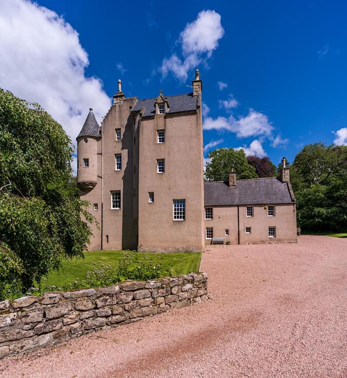 an old castle sitting on top of a stone wall at Lickleyhead Castle in Insch