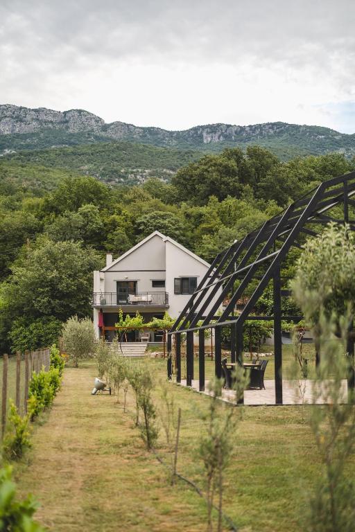 a farm with a building in the background with a bridge at Kami The Essence in Danilovgrad