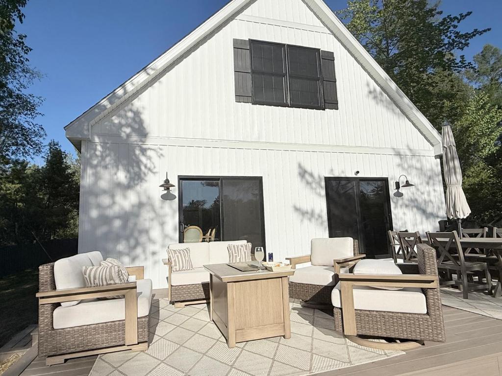 a group of chairs and tables in front of a building at Driftwood on Torch River in Rapid City