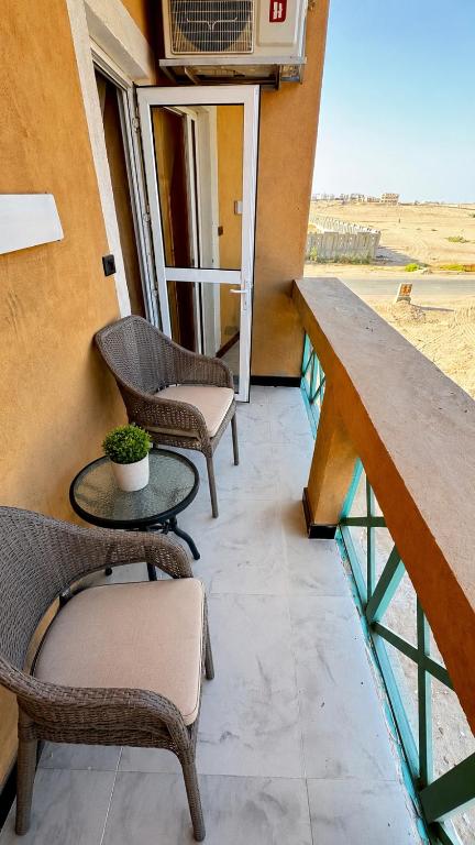 a balcony with two chairs and a table at Sunrise View K8 Apartments in Hurghada