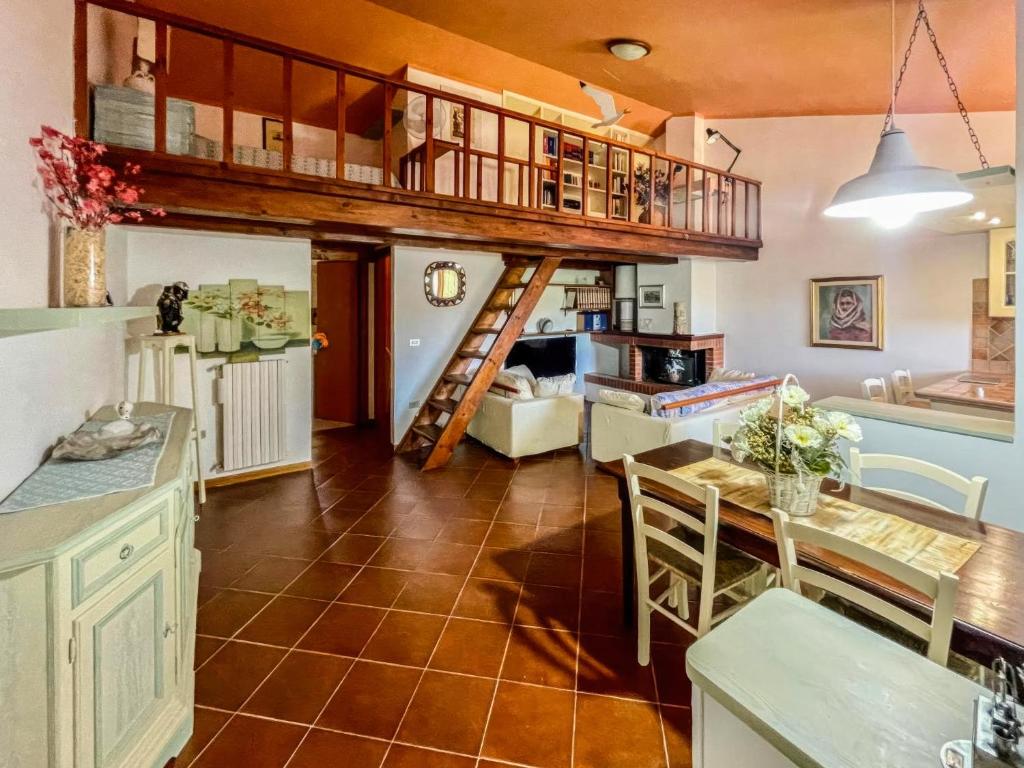 a kitchen and dining room with a loft bed at Amazing house 10 minutes by car from the beach in Olbia