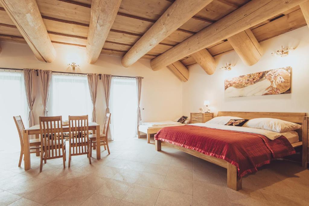 a bedroom with a bed and a table and chairs at Ranč Telč in Telč