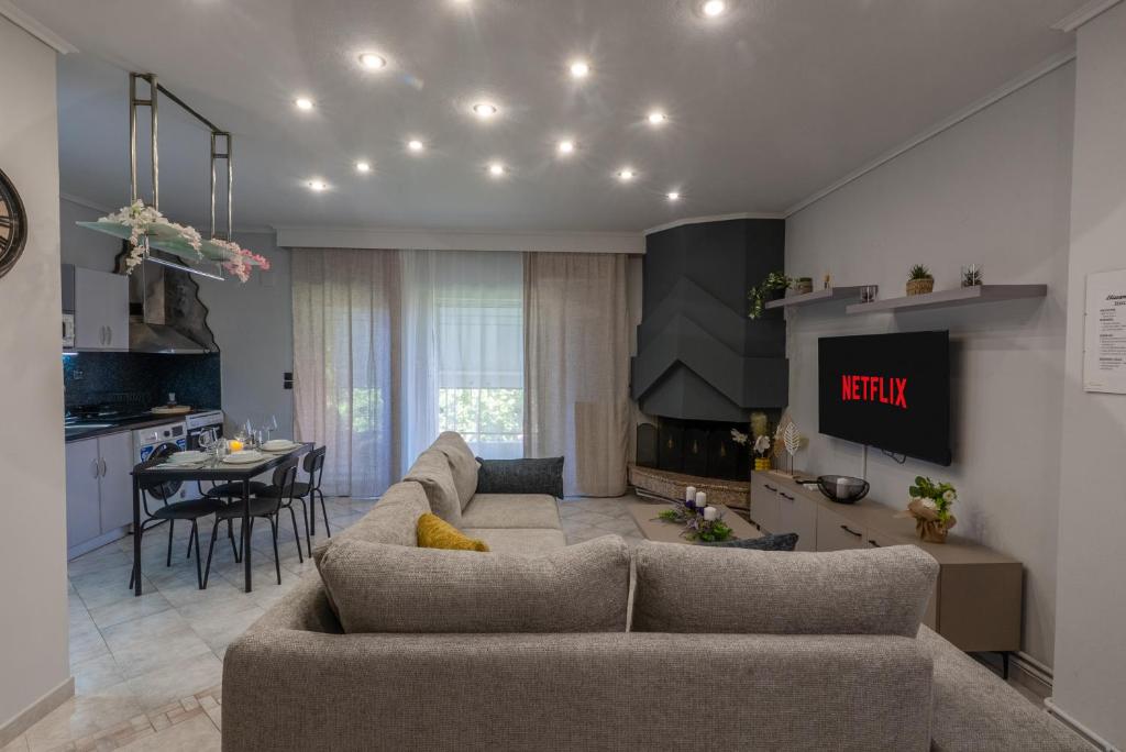 a living room with a couch and a dining room at Elissavet Maison in Perea