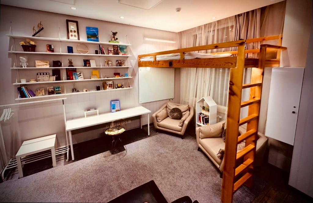 a small room with a desk and a bunk bed at The ALL-in-ONE LOFT with AIRPORT pickup in Ulaanbaatar