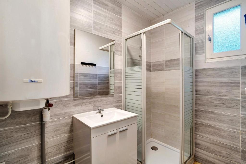 a bathroom with a white sink and a shower at 1.Chataigniers option clim- 4pers in Calviac