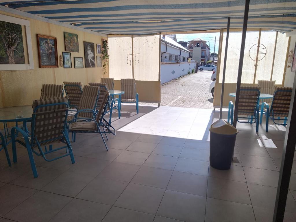 a restaurant with tables and chairs and a street at Casa Ștefan in 2 Mai
