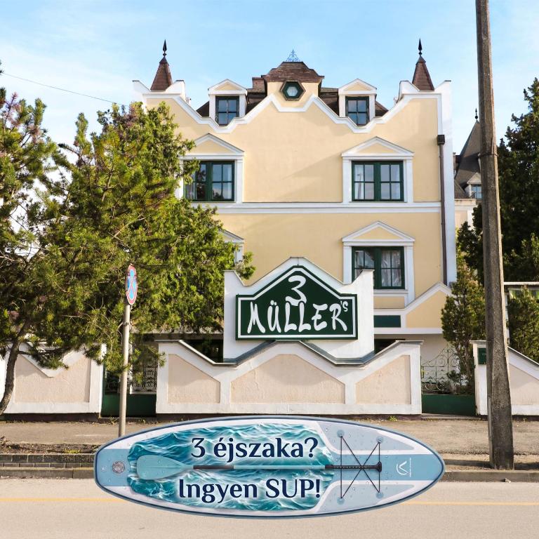 a sign in front of a building at Müller's 3 in Siófok