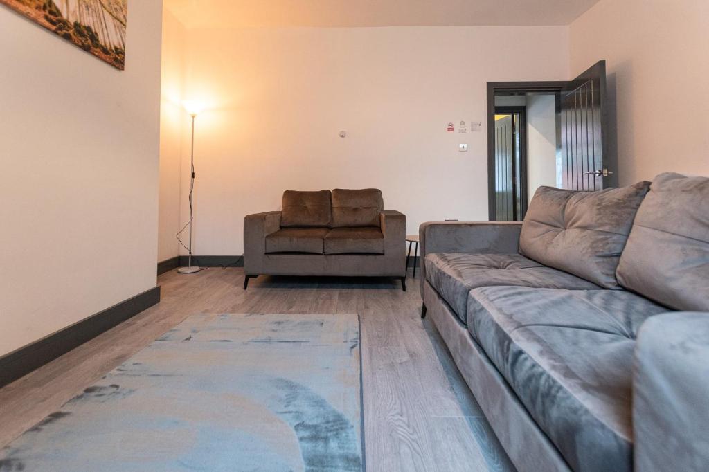 a living room with a couch and a chair at Urmston House in Leigh