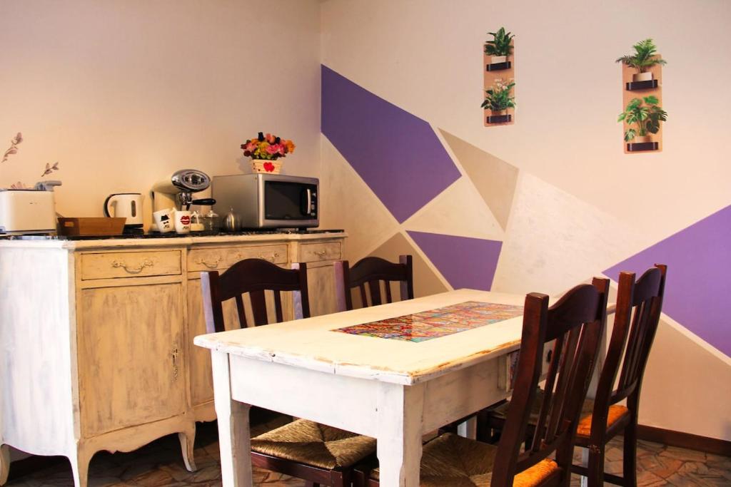 a dining room with a table and chairs and a microwave at Diamante - relax nature , WiFi in Arcumeggia