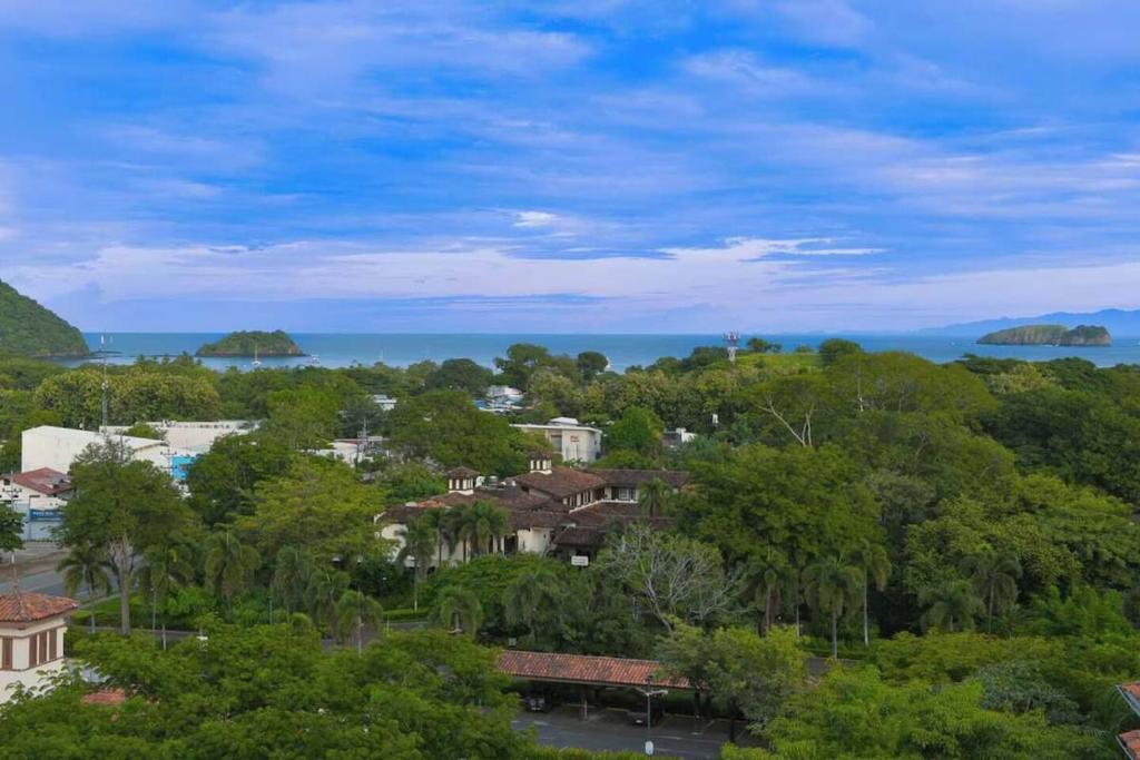 a view of a town with trees and the ocean at Stunning Oceanview Condo with Exceptional Views & Resort-Style Amenities in Coco