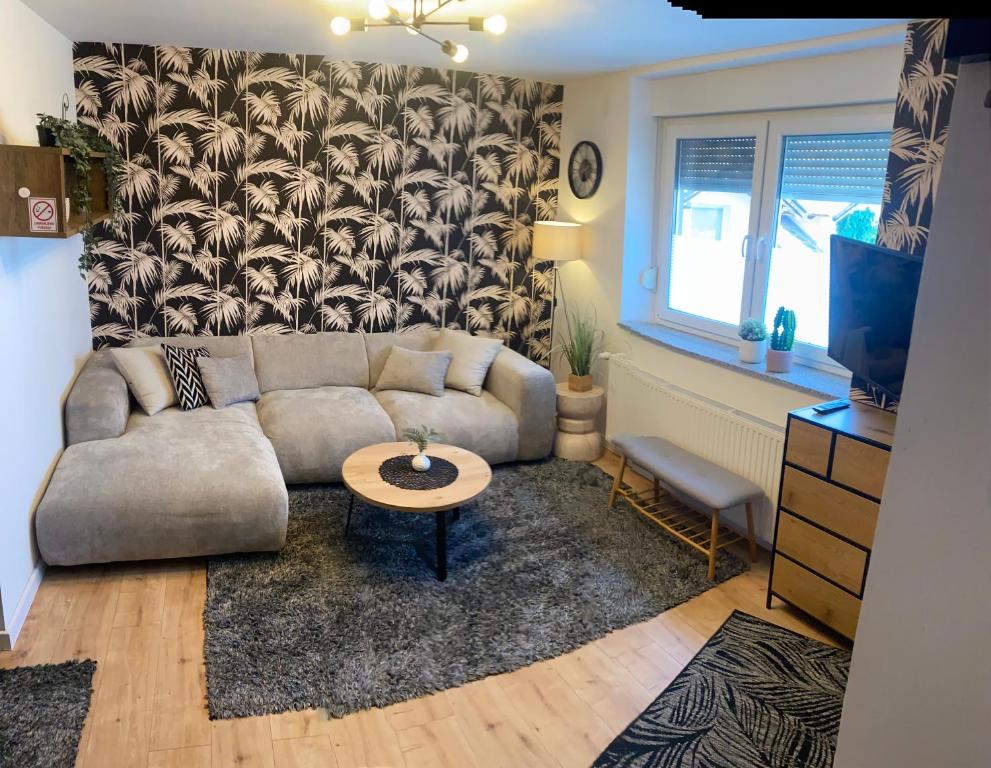 a living room with a couch and a table at Lucy’s apartment in Osijek