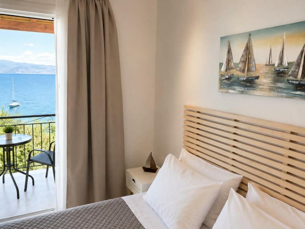 a bedroom with a bed and a view of the ocean at Novus seaview in Benitses