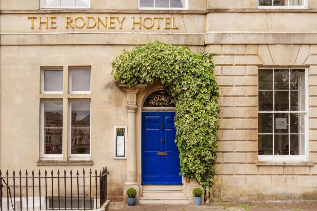 a building with a blue door and ivy at The Rodney Hotel in Bristol