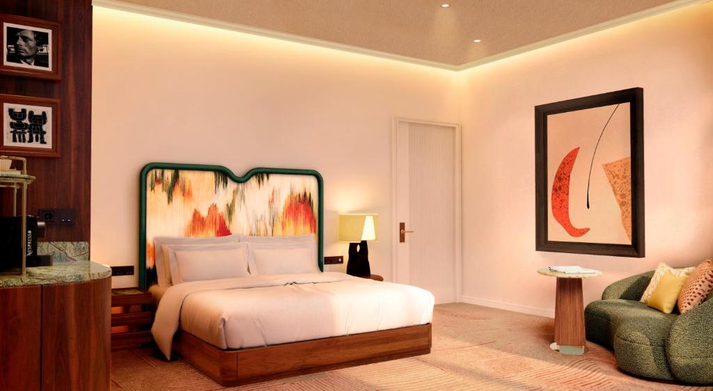 a bedroom with a bed and a chair at Petra Hotel Belgrade in Belgrade