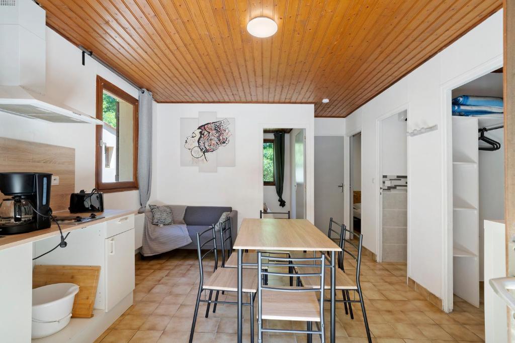 a kitchen and dining room with a table and chairs at 15.La colline Clim.option- 6 pers in Calviac
