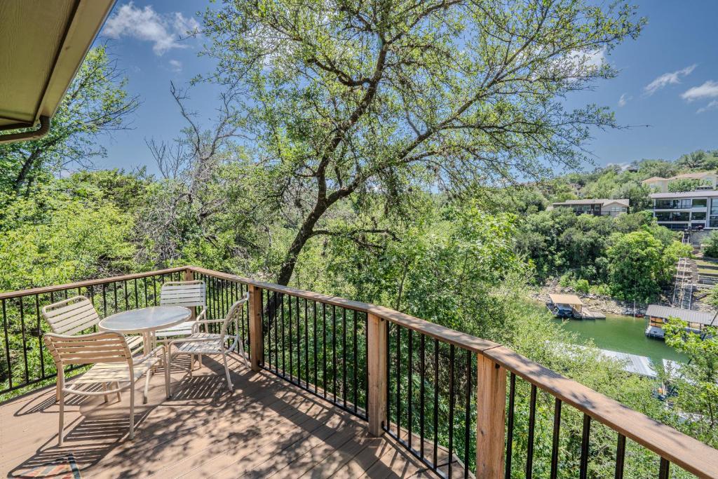 a balcony with a table and chairs overlooking a river at Lakefront Bungalow with Community PoolHot Tub #1 in Lakeway