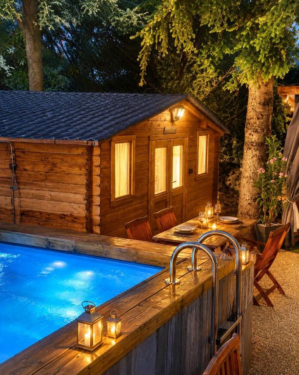 a swimming pool with a house and a hot tub at Chalet Les Buis in Saint-Paul-lès-Romans