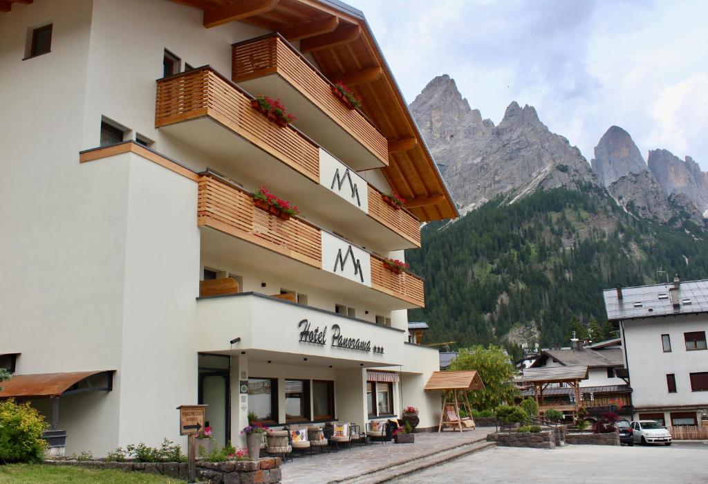 a hotel with a mountain in the background at Hotel Panorama in San Martino di Castrozza
