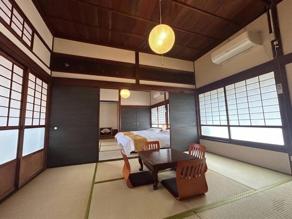a bedroom with a bed and a table and chairs at Sakae - Vacation STAY 41407v in Goto