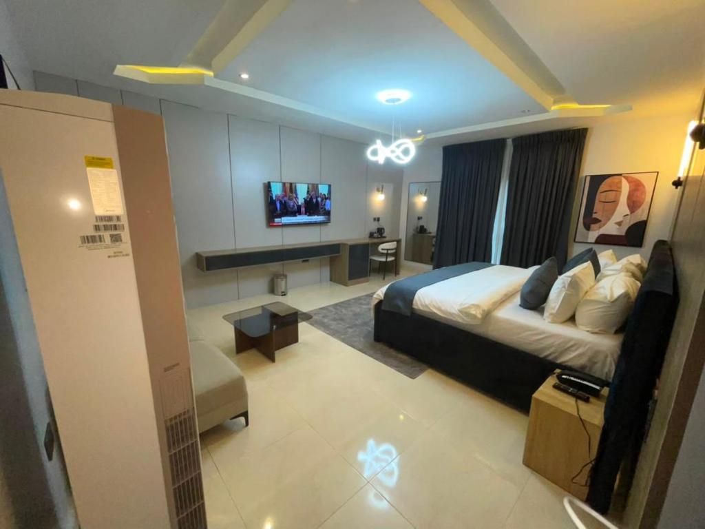 a bedroom with a bed and a tv in it at IP Hotels And Towers in Chori
