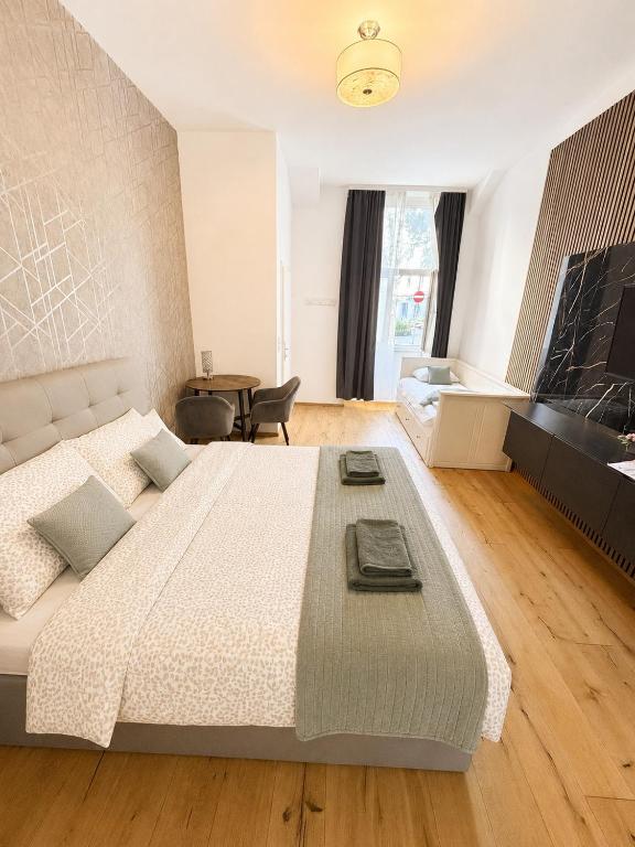 a bedroom with a large bed and a table at City Apartment 1 in Vienna