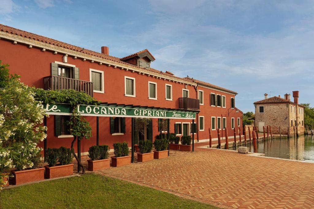 a building with a sign that reads london apartment at Locanda Cipriani in Torcello