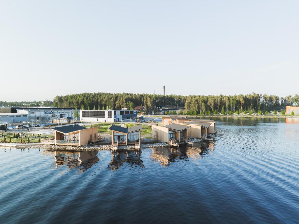 a group of buildings on a dock in the water at Bella Lake Resort in Kuopio