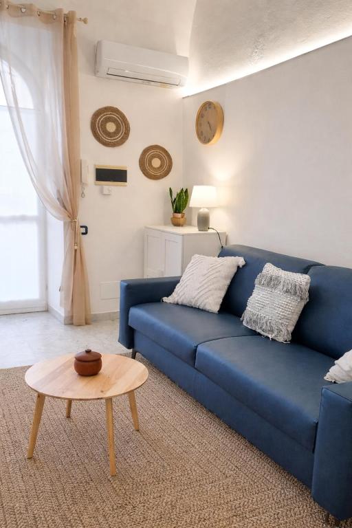 a blue couch in a living room with a table at Casa Mare Blu in Imperia