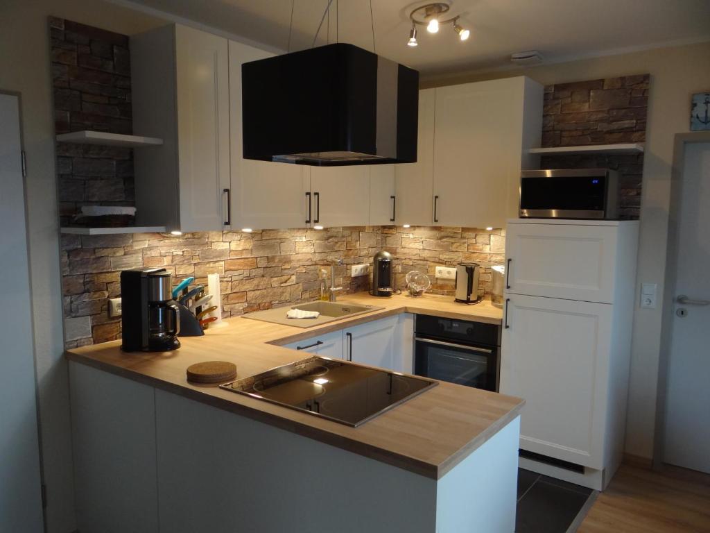 a kitchen with a sink and a counter top at Darssblick Barth - Boddenblick, Tiefgarage & Aufzug in Barth