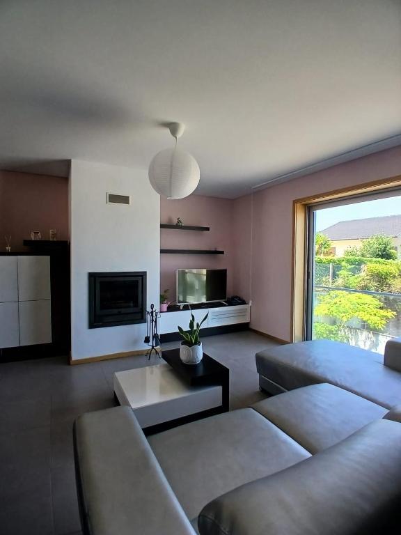a living room with a couch and a table at Casa Estradinha Azul in Amarante