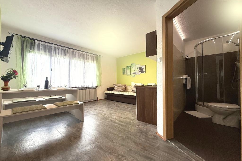 a bathroom with a toilet and a sink and a shower at ASGARD Guesthouse in Josipdol