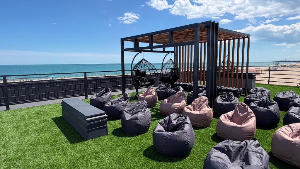 a group of bean bags on the grass near the beach at LESS HOTEL Затока in Zatoka
