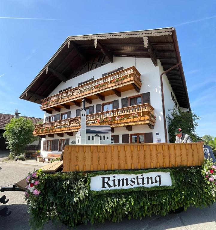 a building with a sign in front of it at Schererhof in Rimsting