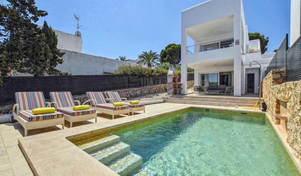 a villa with a swimming pool and a house at Kanavayen Tres in Santanyi