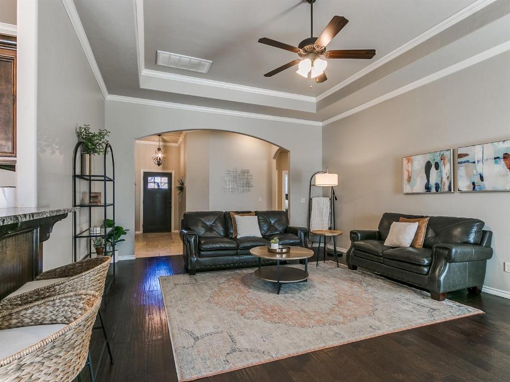 a living room with leather furniture and a ceiling fan at Where Comfort Meets Luxury in Yukon