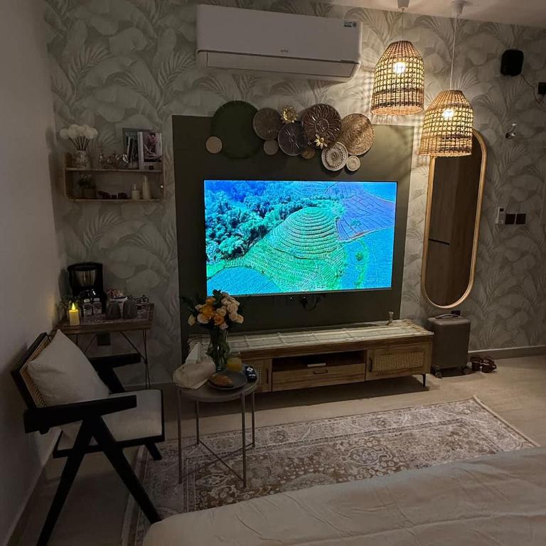 a living room with a large flat screen tv at Bali island Studio in Al Khobar