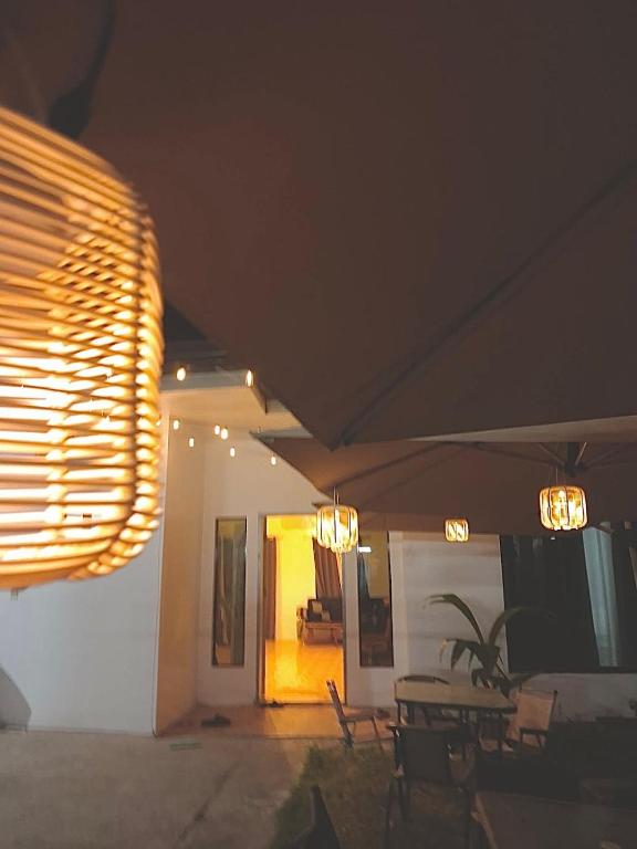 a room with a table and chairs and a light at Nomads Retreat House in Moalboal