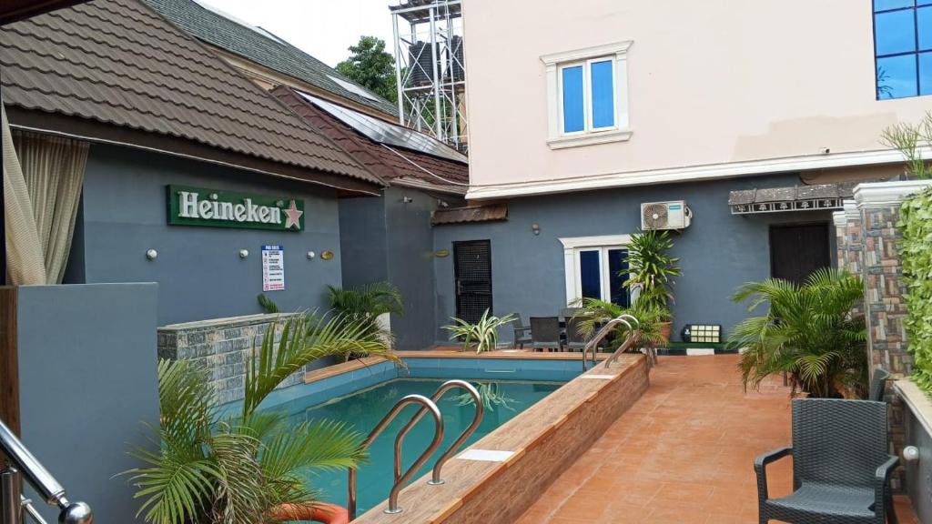 a house with a swimming pool in front of it at Clover Apartments and suites in Abuja
