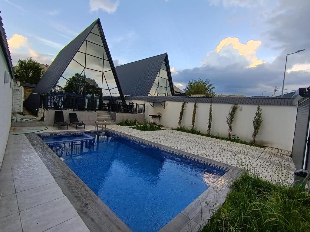 a swimming pool in front of a building at Gabala A frame Guest villa in Gabala