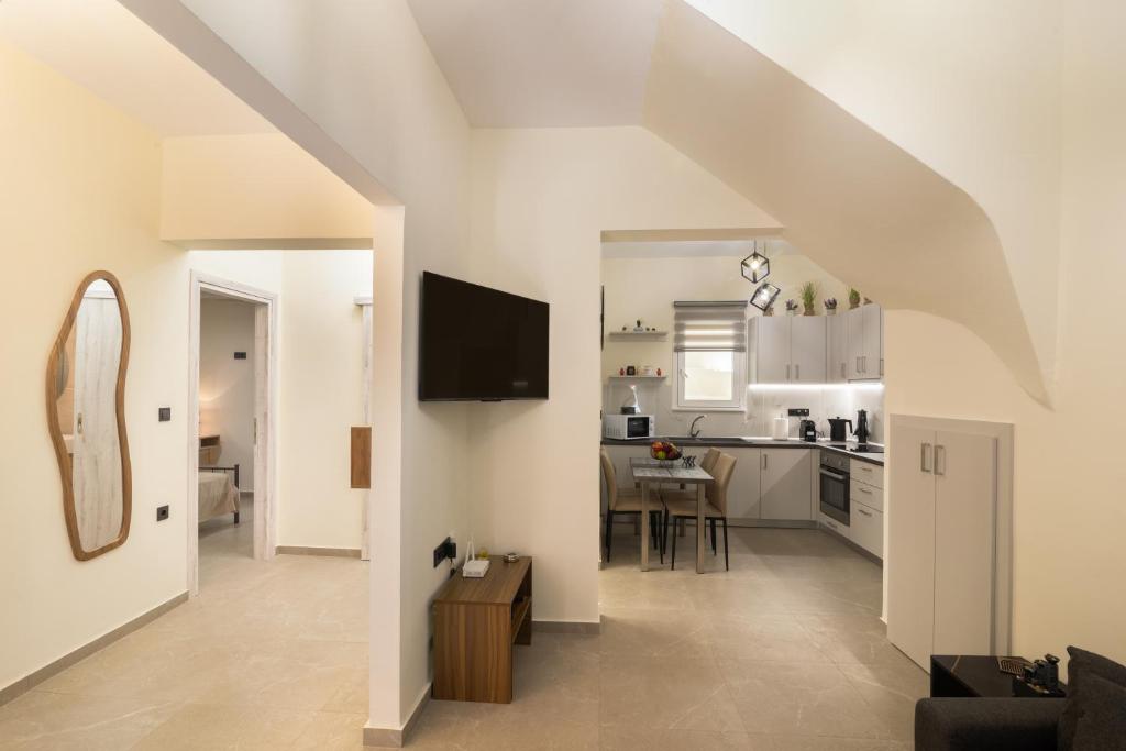 a living room and kitchen with white walls at Stellasrooms in Mytilene