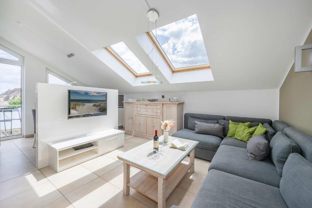 a living room with a couch and a table at Haus Ostseekristall Wohnung Rubin in Zinnowitz