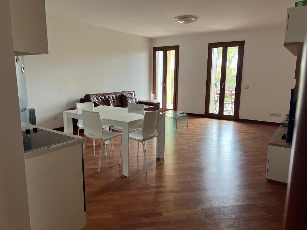 a kitchen and dining room with a white table and chairs at Little Venice in Sacile