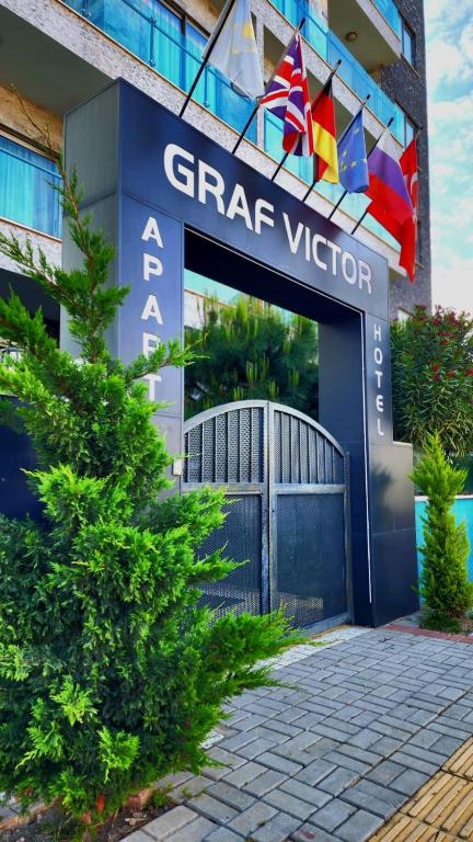 a facade of a building with flags in front of it at Graf Victor Apart Hotel in Alanya