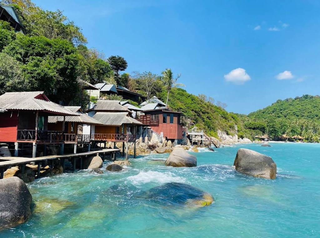 a river with a group of houses on the shore at OK Bungalow in Ko Tao