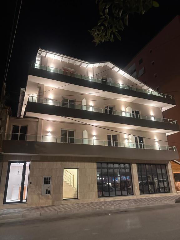 a large building with lights on at night at Kanaj Rooms and Apartments in Vlorë