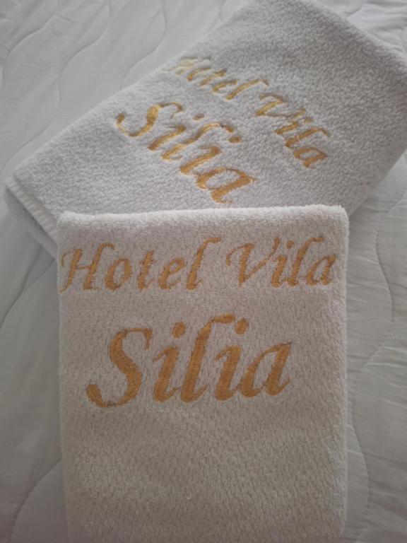 a towel with the words hotelilla shuttle on a bed at Vila Silia in Skopje