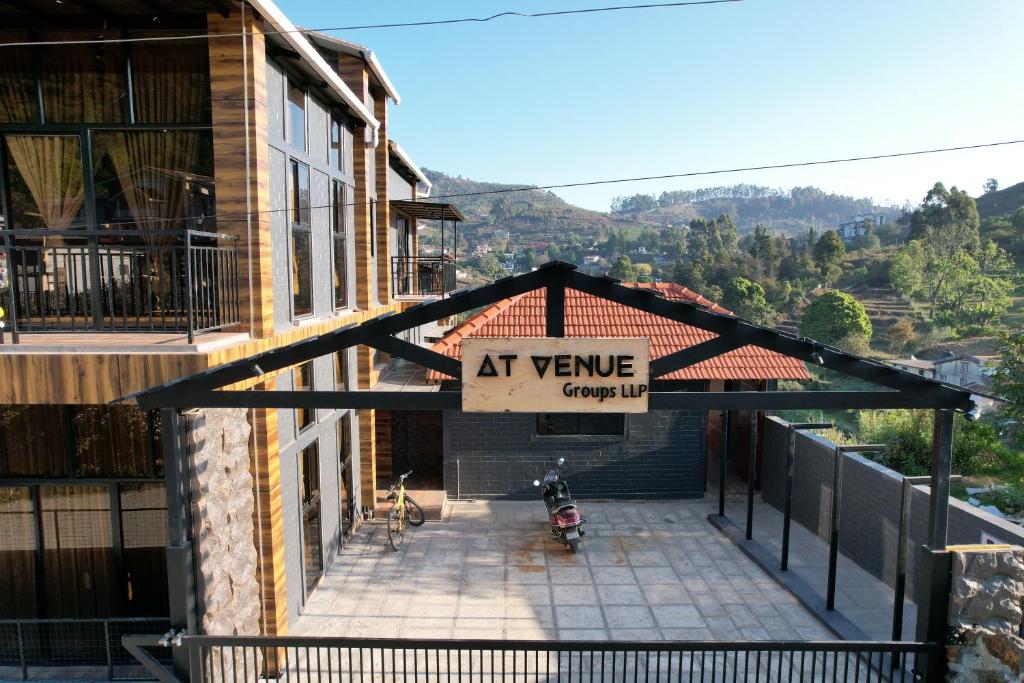 an entrance to a building with a sign that reads at vine group inn at At Venue Groups in Kodaikānāl