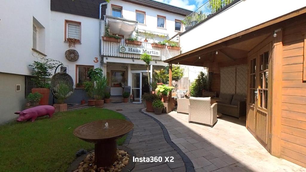 a courtyard of a building with a table in the yard at Pension Martin Zimmer & Apartment in Bad Camberg