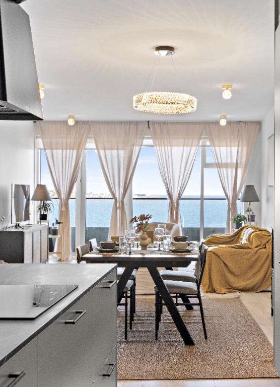 a kitchen with a dining table with a view of the ocean at Premium Ice Apartments Atlantic Ocean Magic View in Reykjavík